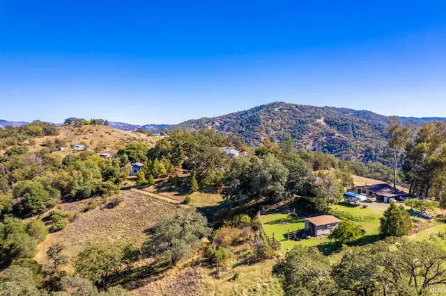 a open kitchen with stainless steel appliances kitchen island granite countertop a refrigerator and a stove