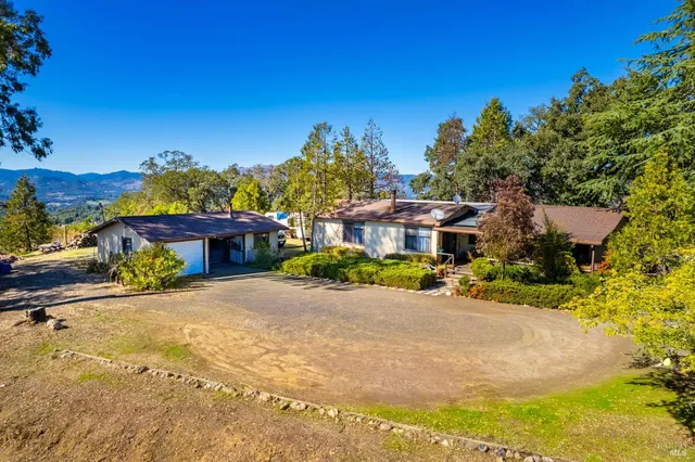 a view of a kitchen with a sink and a large window