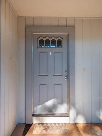 a view of a hallway with closet and a bathroom