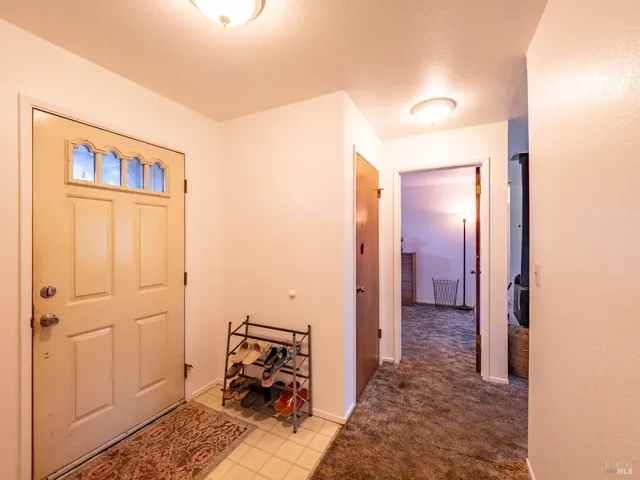 a dining room with furniture a rug and a chandelier