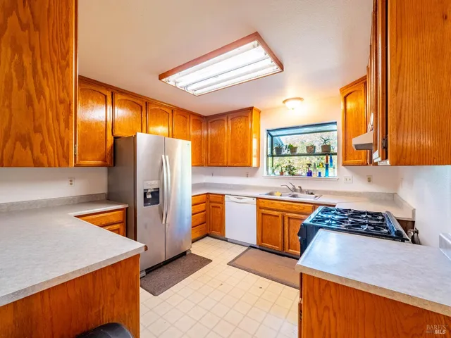 a kitchen with wooden cabinets and a stove