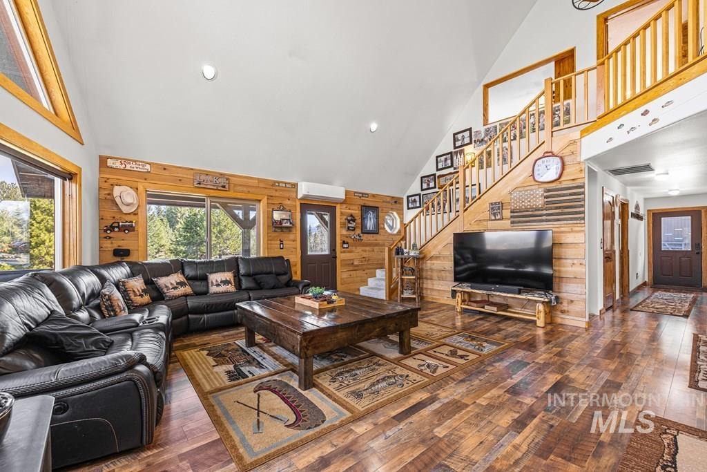 30 Redtail Lane McCall, ID 83638 - Photo 22 of 50 Living area with wooden walls, dark wood-style flooring, vaulted ceiling, and recessed lighting