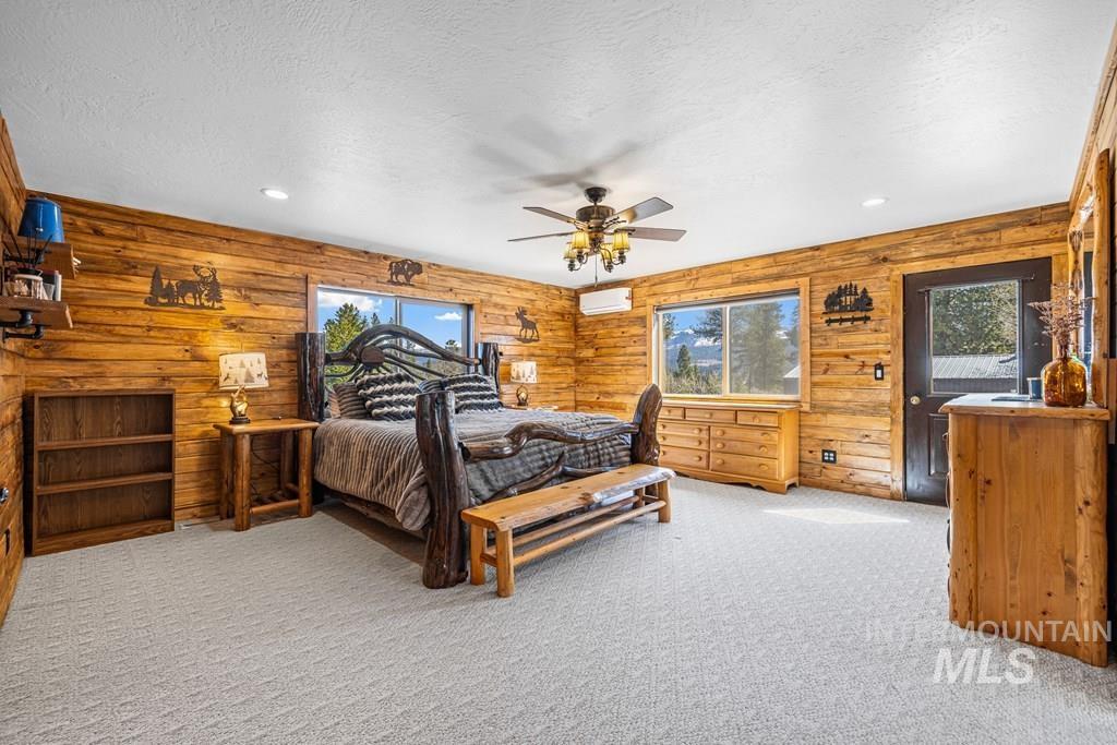 30 Redtail Lane McCall, ID 83638 - Photo 27 of 50 Bedroom with light colored carpet, access to outside, recessed lighting, a ceiling fan, and a textured ceiling