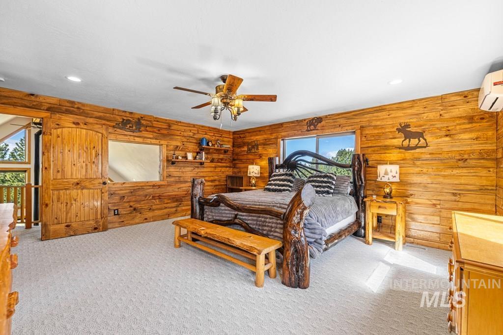 30 Redtail Lane McCall, ID 83638 - Photo 29 of 50 Bedroom featuring wood walls, light carpet, recessed lighting, and ceiling fan