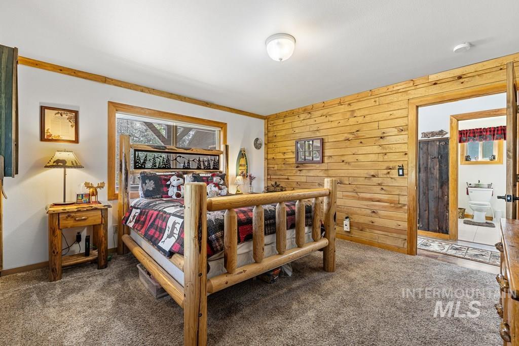 30 Redtail Lane McCall, ID 83638 - Photo 30 of 50 Bedroom featuring wood walls and dark colored carpet