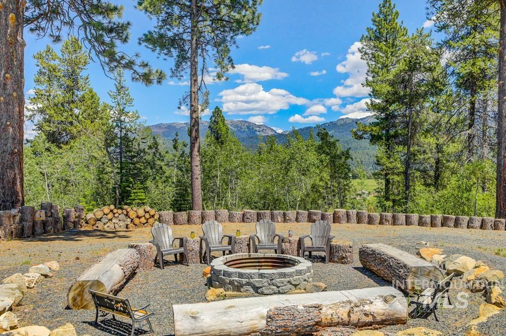 30 Redtail Lane McCall, ID 83638 - Photo 40 of 50 View of patio / terrace with an outdoor fire pit and a mountain view