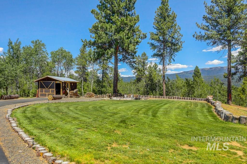 30 Redtail Lane McCall, ID 83638 - Photo 41 of 50 View of green lawn featuring a mountain view and an outbuilding