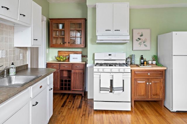 a kitchen with a white cabinets and white appliances