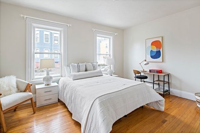 a bedroom with a bed and a chair