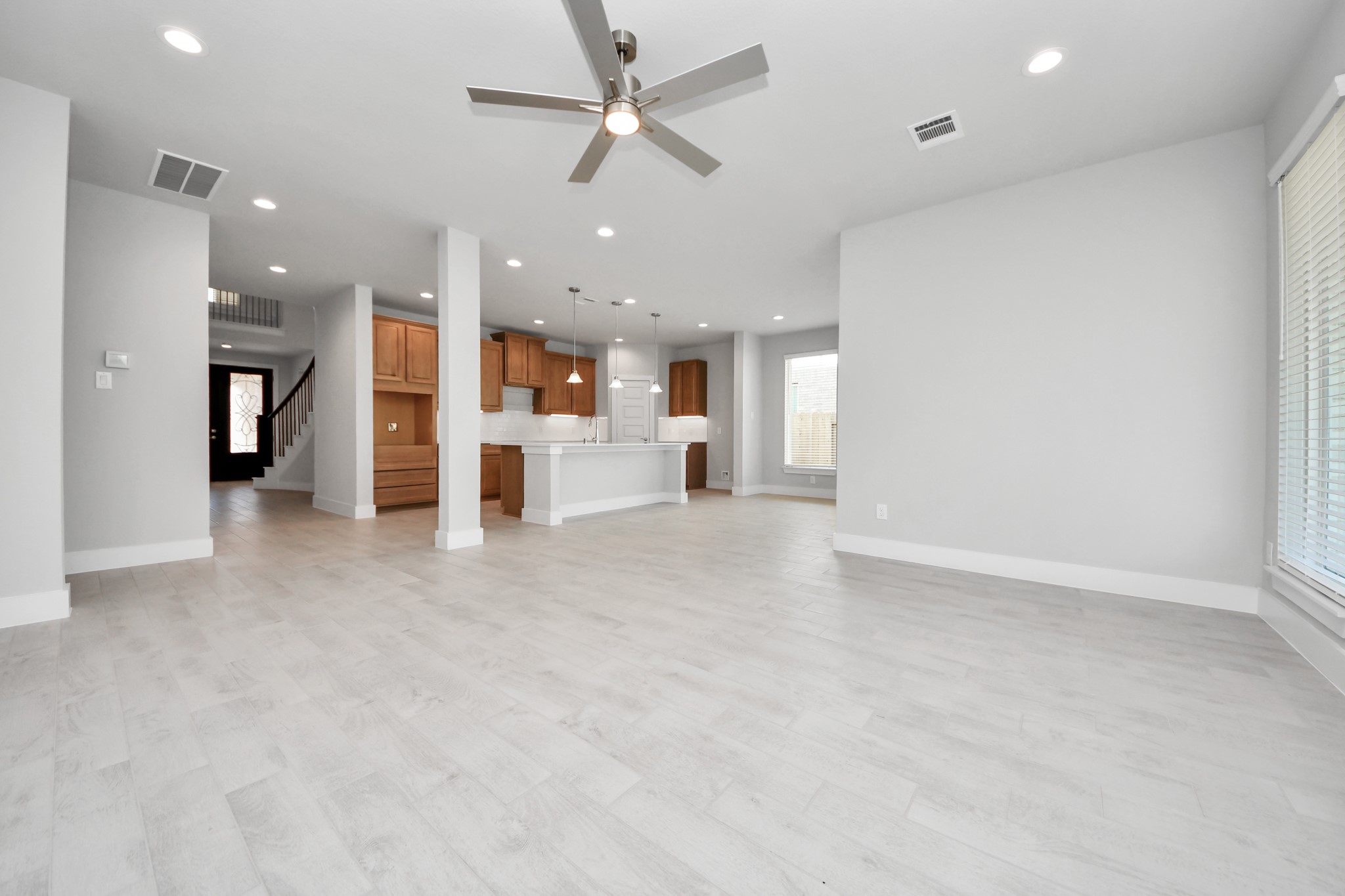 3102 Native Spg Drive Spring, TX 77373 - Photo 17 of 40 Gather the family and guests together in your lovely living room! Featuring soaring high ceilings, recessed lighting, ceiling fan, custom paint, gorgeous floors, and large windows that provide plenty of natural lighting throughout the day. Sample photo of completed home with similar floor plan. Actual colors and selections may vary.