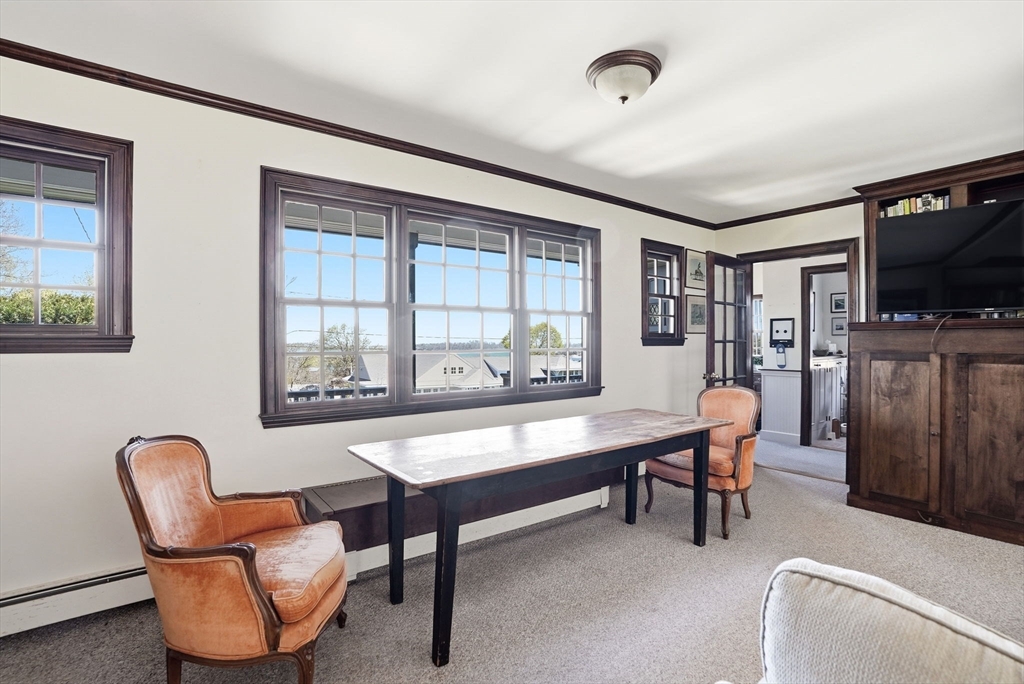 34 Governor Long Road Hingham, MA 02043 - Photo 3 of 37 a living room with furniture a flat screen tv and a window