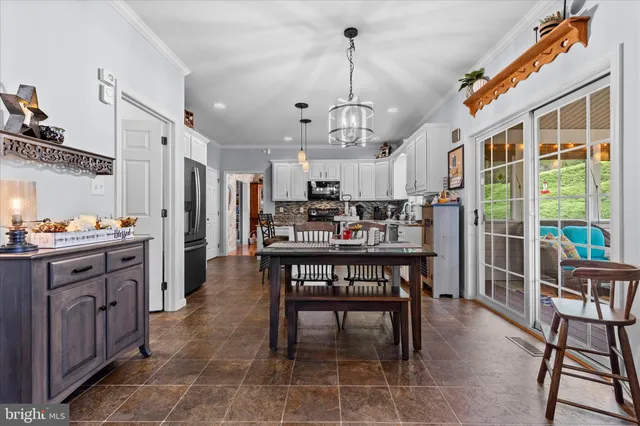 a living room with furniture a flat screen tv and a large window
