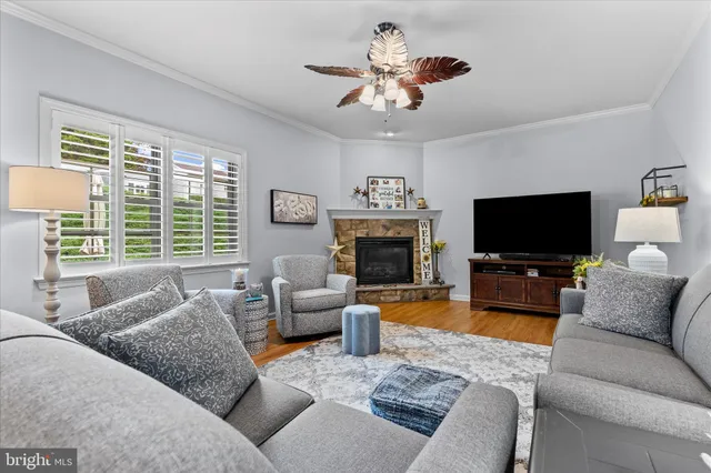 a living room with furniture kitchen view and a large window