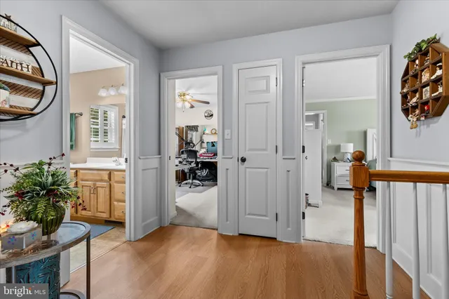 a bathroom with a sink a toilet and a large mirror