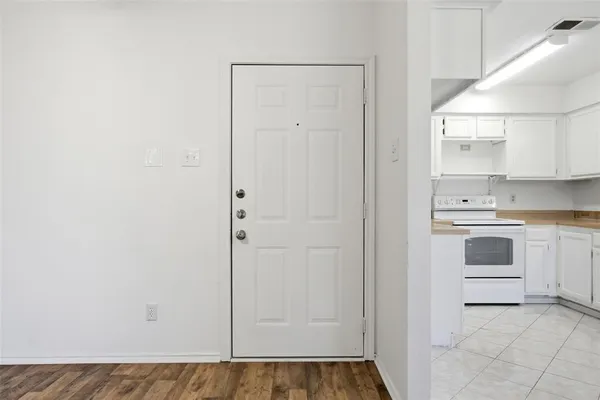 a view of a kitchen with white cabinets and white appliances