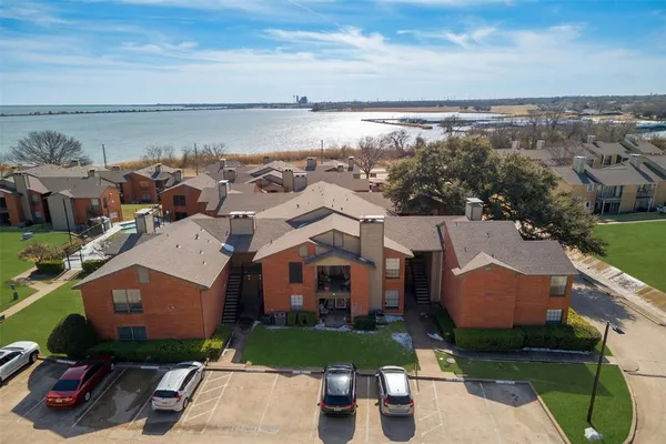 an aerial view of multiple houses with a yard