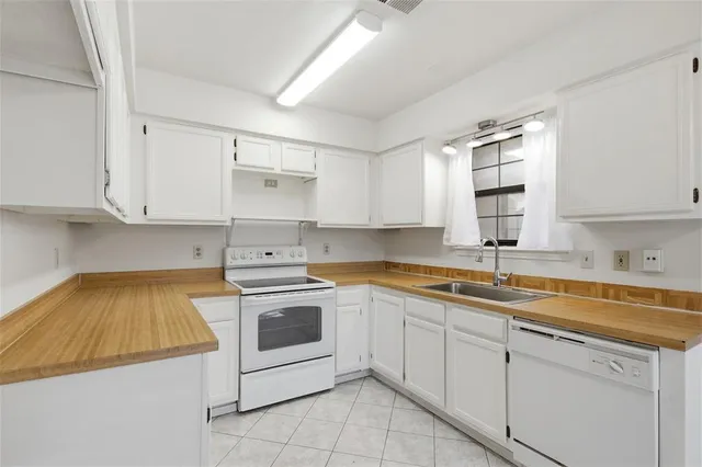 a kitchen with a sink stove and cabinets
