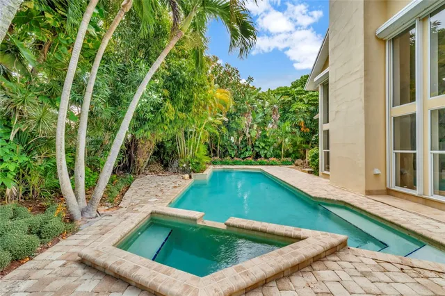 a view of a backyard with swimming pool