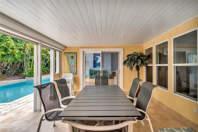 a dining room with furniture wooden floor and a floor to ceiling window