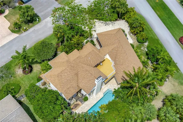 an aerial view of a house with a yard and a garden