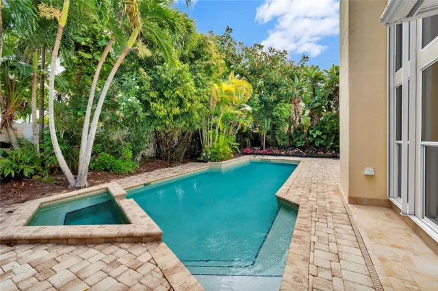 a view of backyard with swimming pool