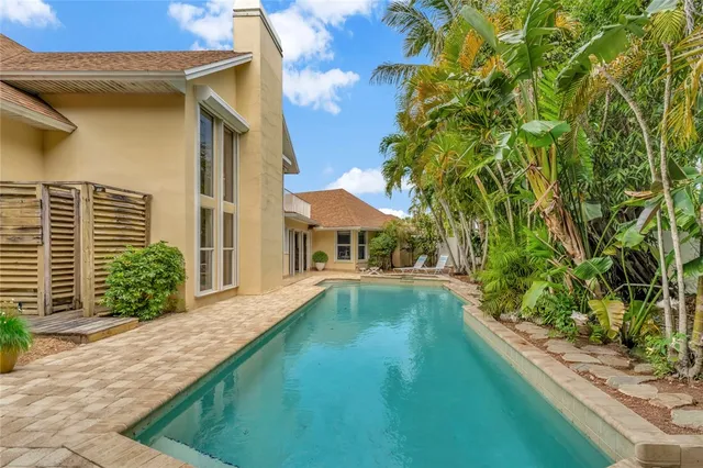 a house with swimming pool in front of it