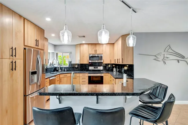 a kitchen with a dining table and chairs