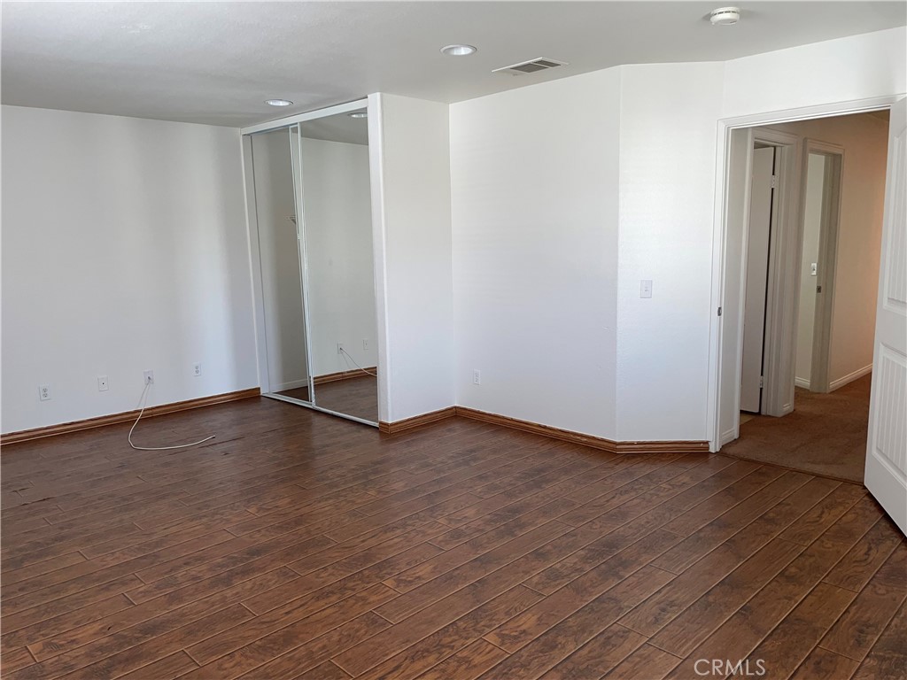 12661 Luna Road Victorville, CA 92392 - Photo 19 of 20 a view of an empty room with wooden floor