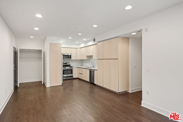 an empty room with wooden floor and sliding door