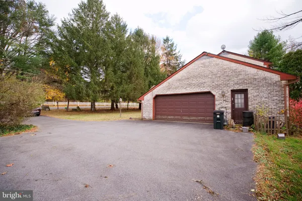 a view of house with outdoor space and parking