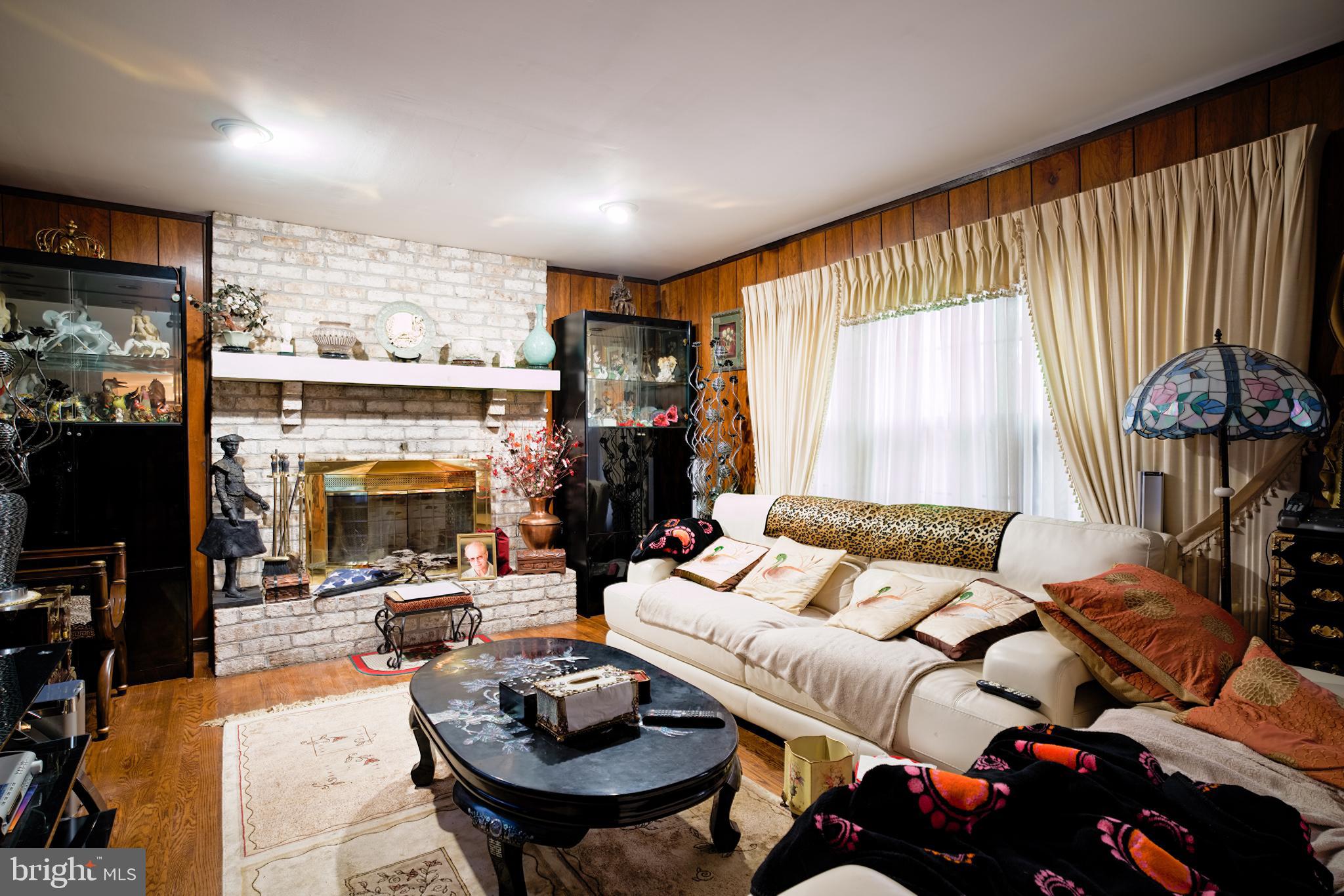 2713 Center Street Bethlehem, PA 18017 - Photo 8 of 11 a living room with furniture a fireplace and a large window
