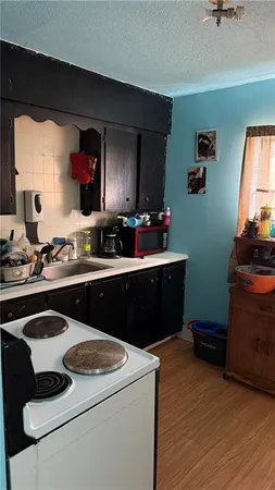 a kitchen with a sink stove and cabinets