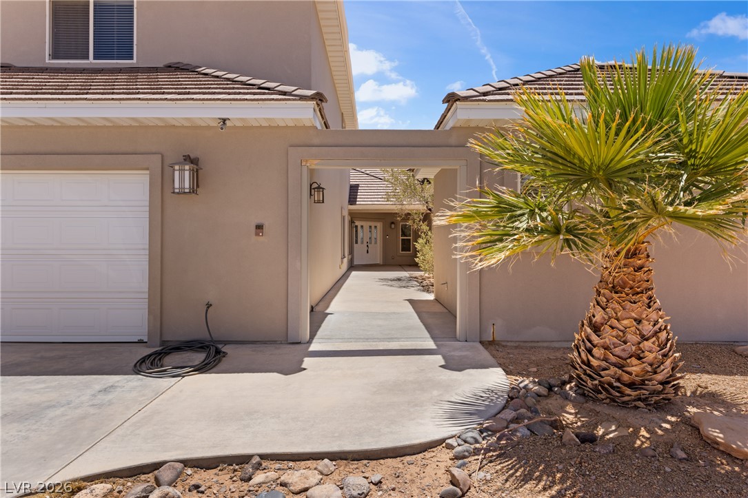 575 Gann Avenue Logandale, NV 89021 - Photo 61 of 75 An inviting entry leads through a covered walkway, revealing a glimpse of the home's facade.
