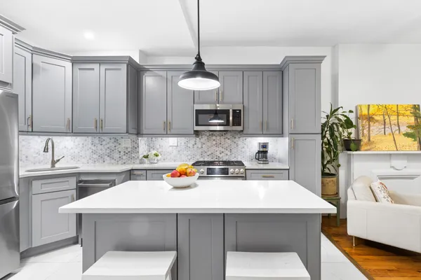 a kitchen with a sink a microwave and cabinets