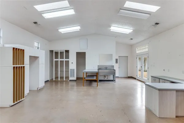 a living room with furniture and a kitchen view