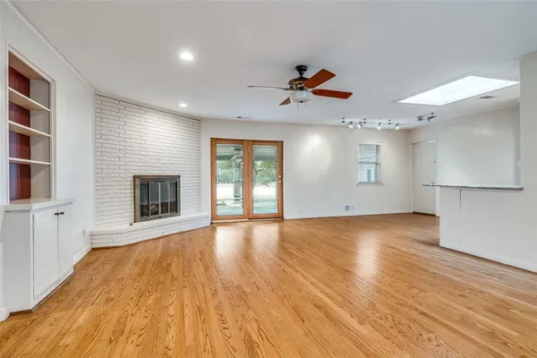 a view of a livingroom with a fireplace and window