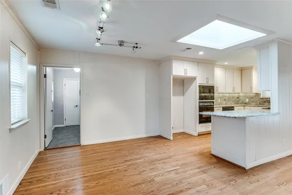 a view of kitchen appliances and cabinets