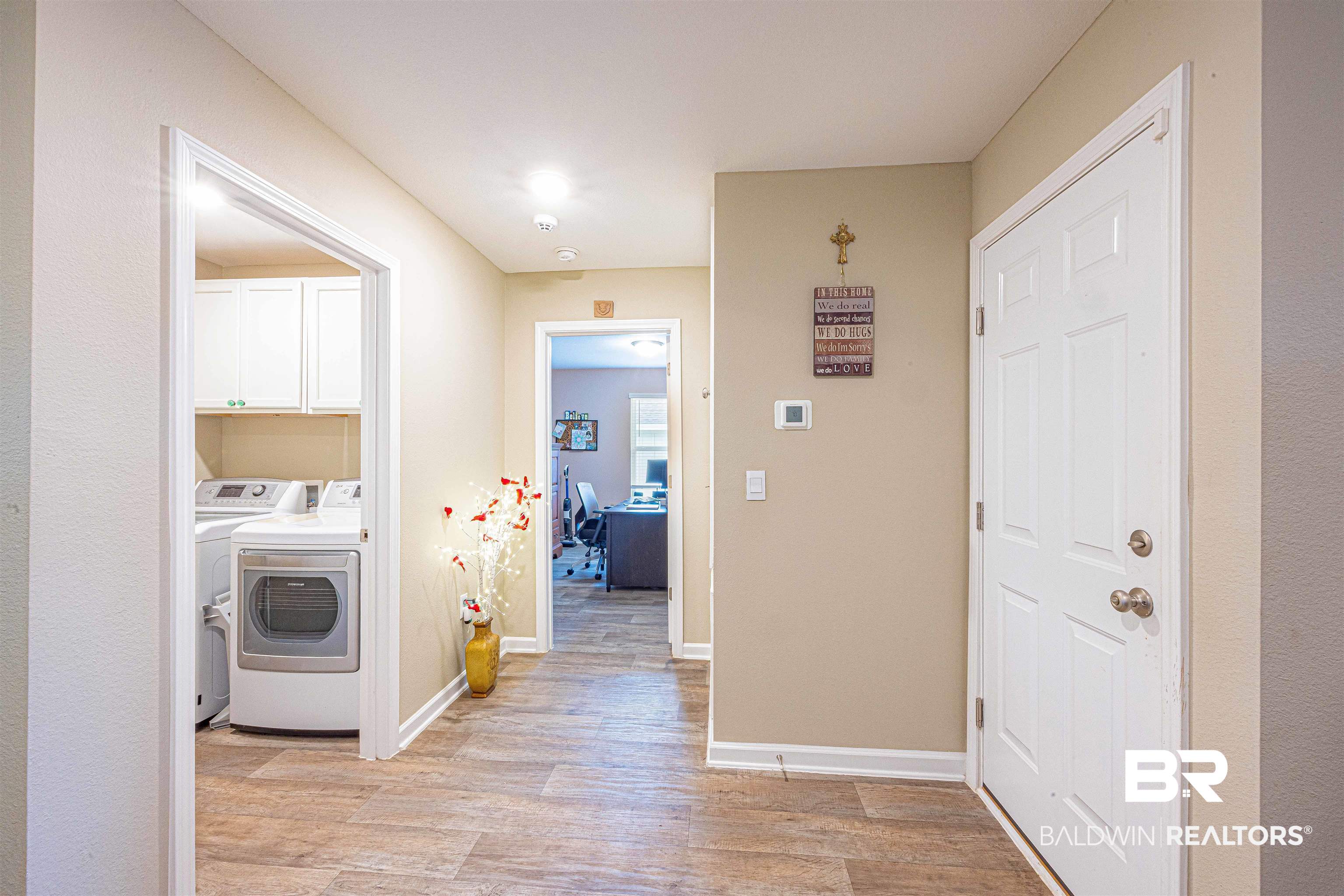 14843 Forsythia Loop Silverhill, AL 36576 - Photo 34 of 51 Laundry room featuring light wood-style flooring, washing machine and clothes dryer, and cabinet space