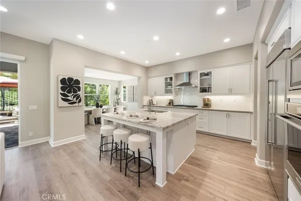 a kitchen with granite countertop cabinets stainless steel appliances and wooden floor