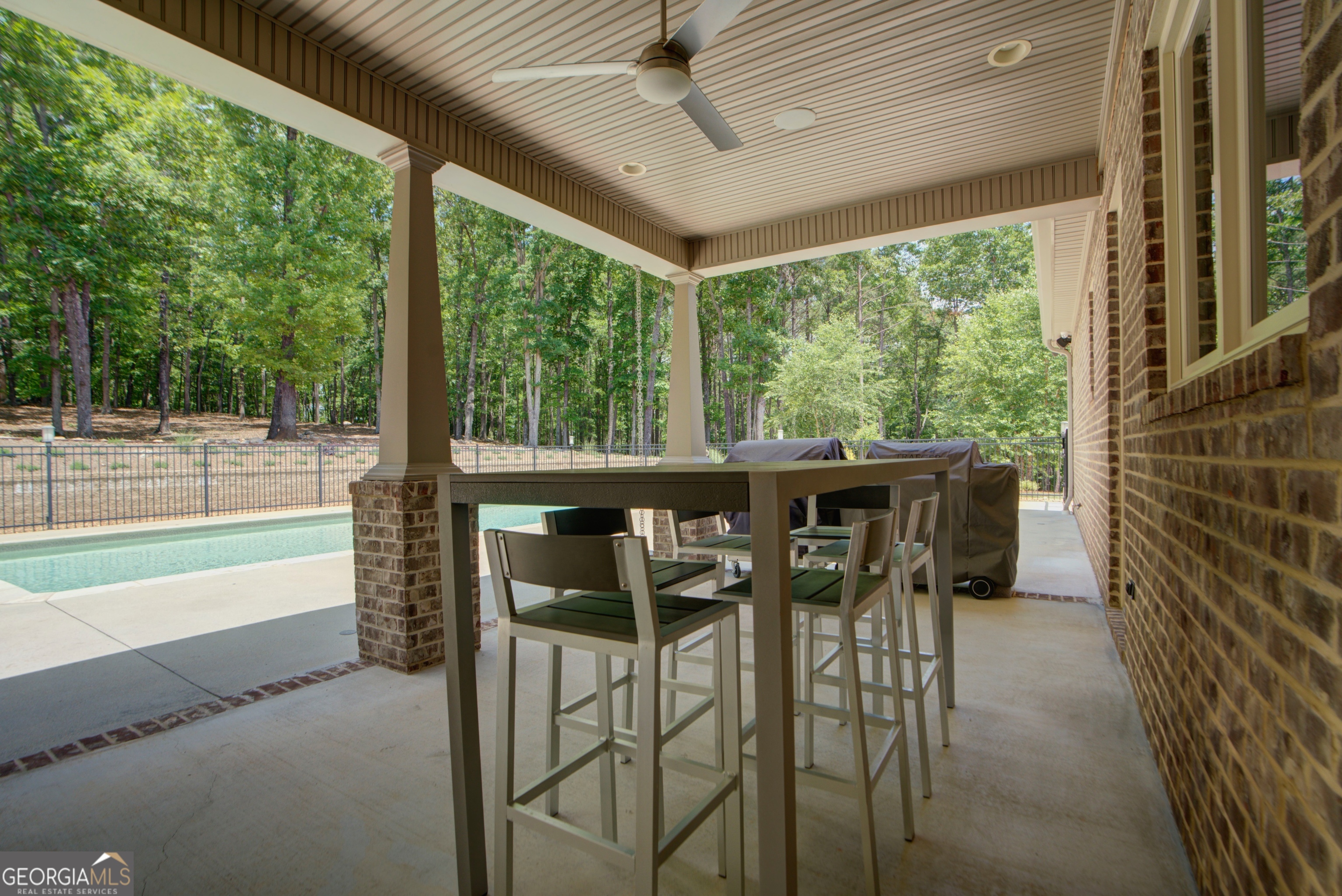 610 Kings Bridge Road Cave Spring, GA 30124 - Photo 47 of 72 a view of a patio with table and chairs and floor to ceiling window