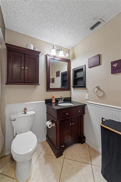 8715 Huntsman Lane Port Richey, FL 34668 - Photo 35 of 54 a bathroom with a toilet a sink and a microwave