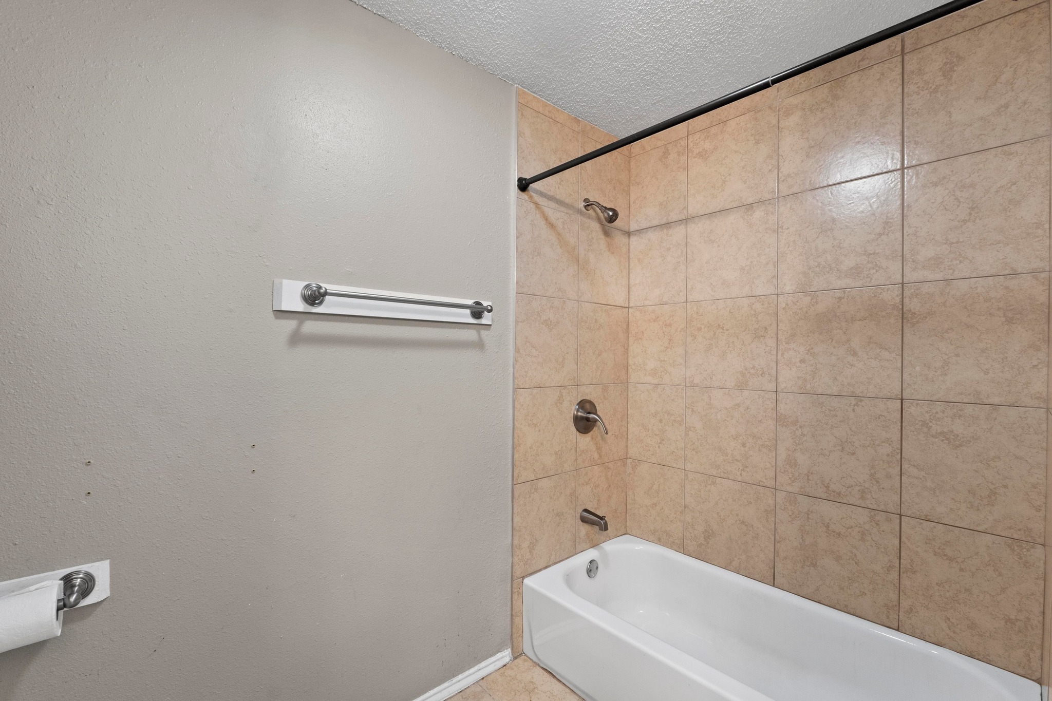 4208 Duval Road, Unit C Austin, TX 78759 - Photo 17 of 28 Full bath with bathing tub / shower combination and a textured ceiling