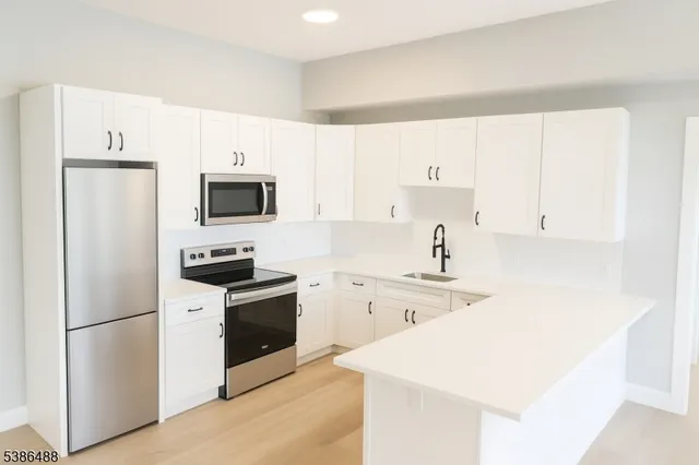 a kitchen with a sink a stove and refrigerator