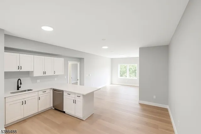 a kitchen with white cabinets and white appliances