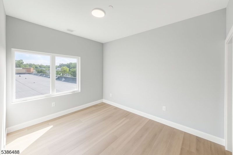 391 Springfield Avenue, Unit 3H Berkeley Heights, NJ 07922 - Photo 6 of 14 a view of an empty room with a window