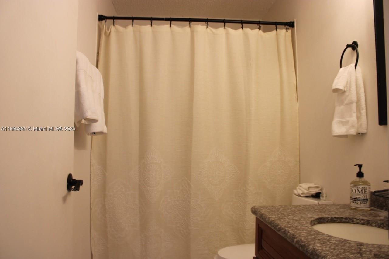 5181 Kim Court West Palm Beach, FL 33415 - Photo 12 of 24 a bathroom with a granite countertop sink and a mirror