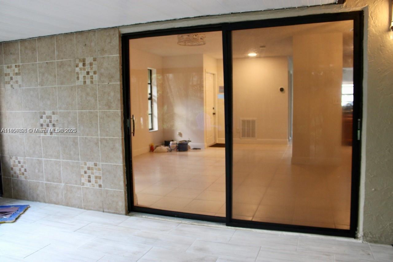 5181 Kim Court West Palm Beach, FL 33415 - Photo 16 of 24 a view of a bathroom with a glass door