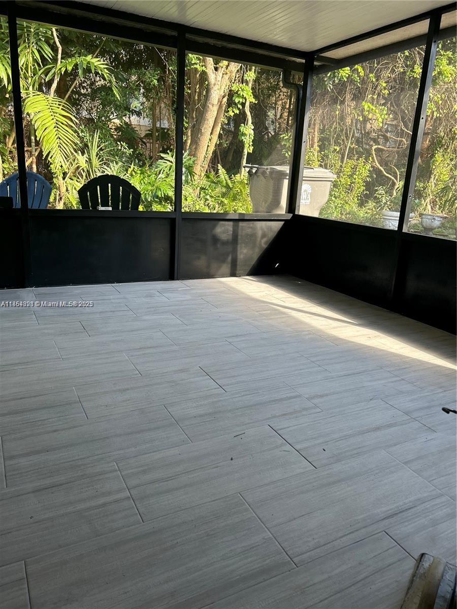 5181 Kim Court West Palm Beach, FL 33415 - Photo 17 of 24 a view of empty room with wooden floor and windows