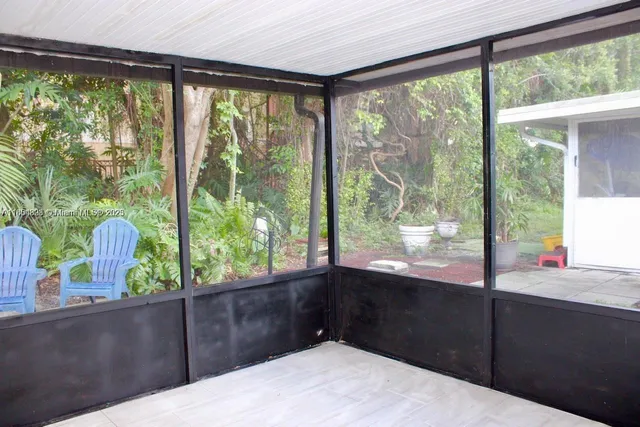 a bedroom view with a large window