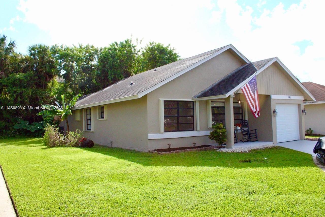 5181 Kim Court West Palm Beach, FL 33415 - Photo 20 of 24 a view of a house with backyard and porch